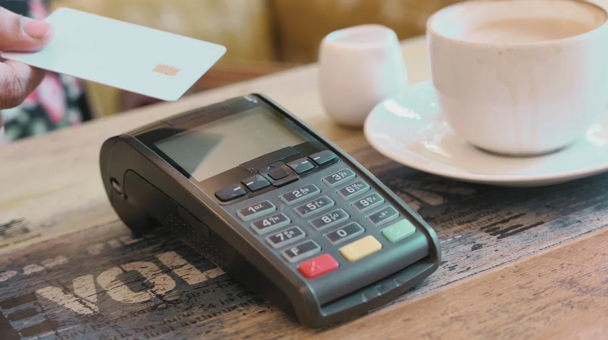 Small business owner using a digital point-of-sale system in a Malaysian retail store
