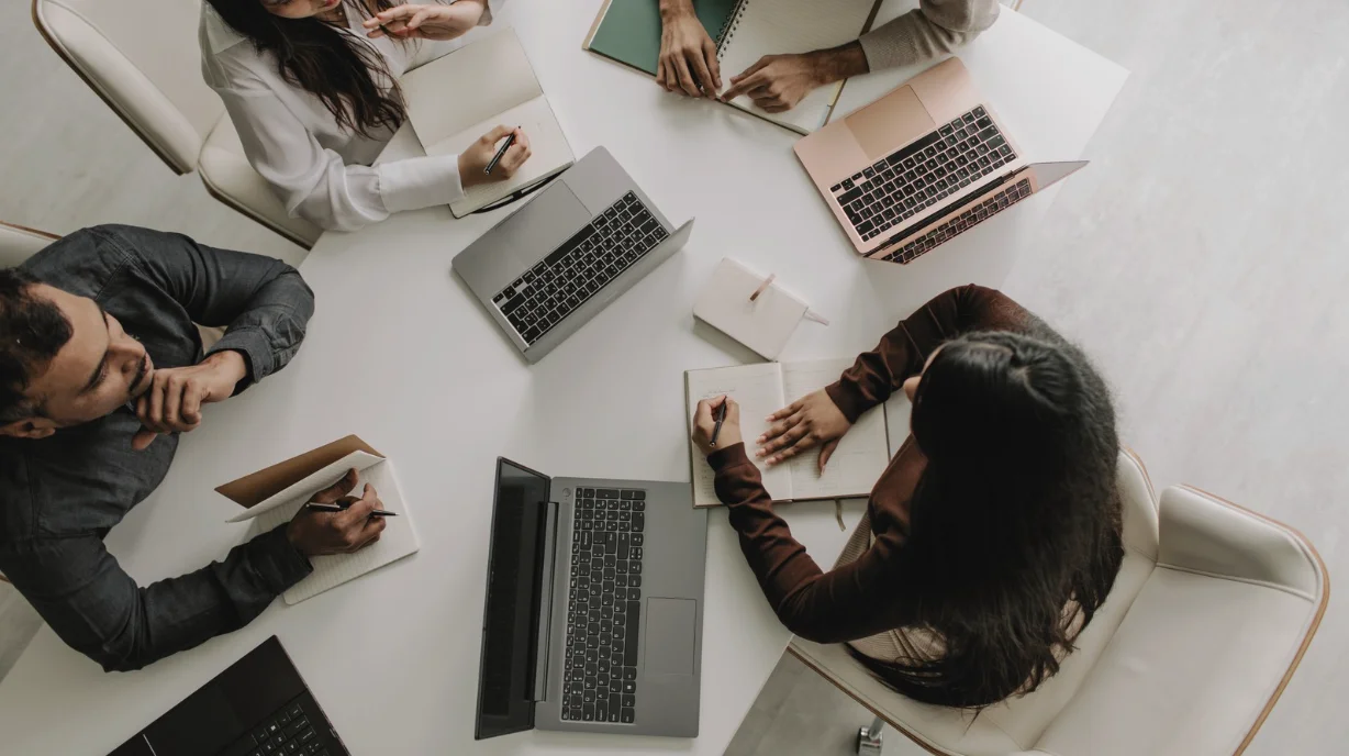 Image alt text: Malaysian university interns working alongside staff in a small business office